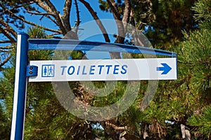 French word `Toilettes` means toilet on a direction sign photo